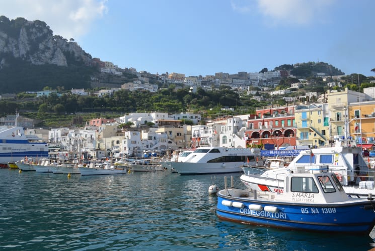 Boats and colorful buildings on the coast of Italy.