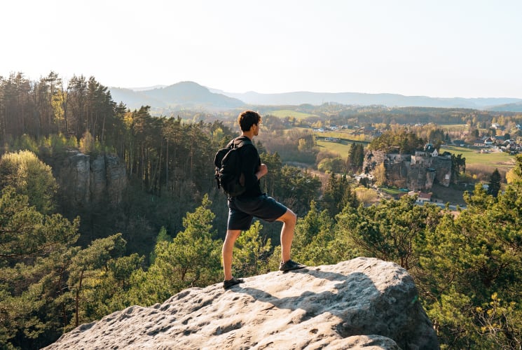 A student standing on a cliff overlooking Bohemian Switzerland National Park.