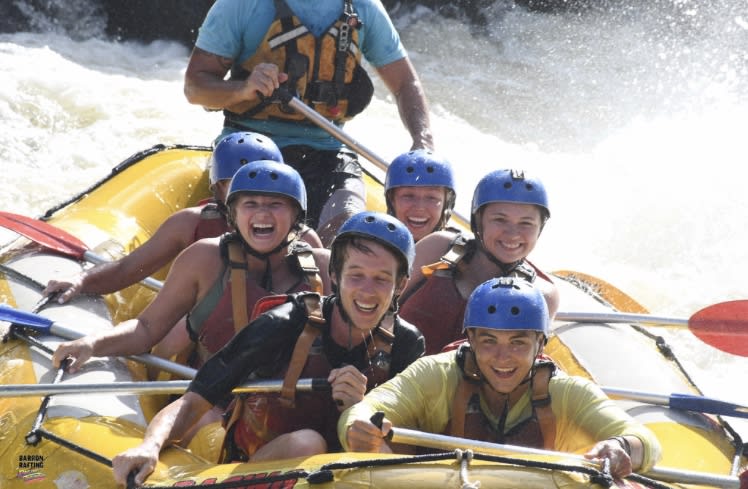A group of students white water rafting.