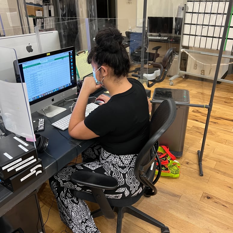 A student working at a desktop computer.