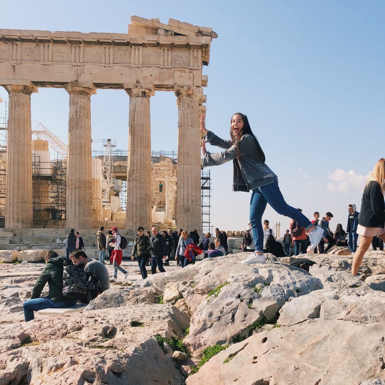 A student posing in front of the Parthenon.